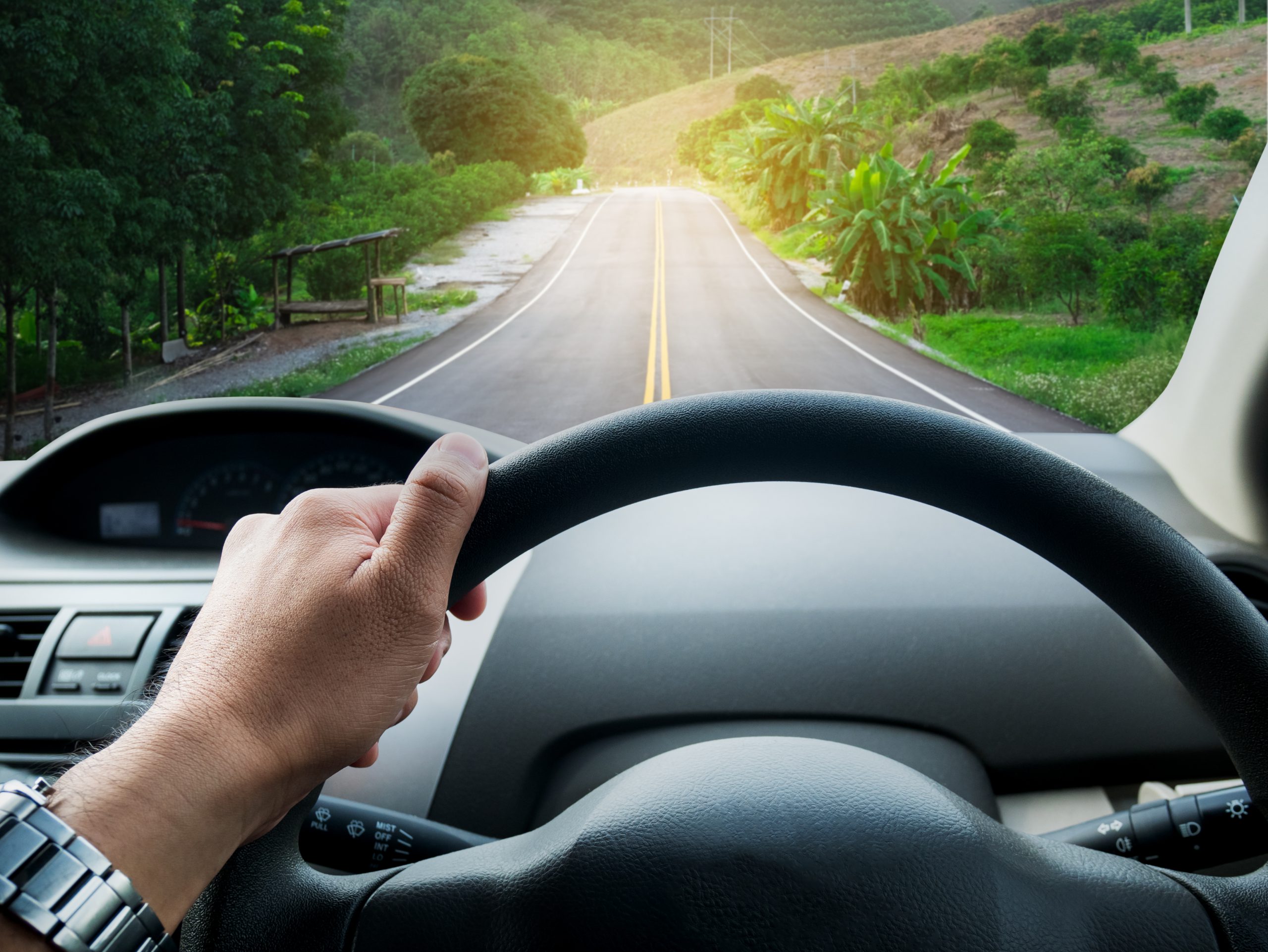 man driving car on the road
